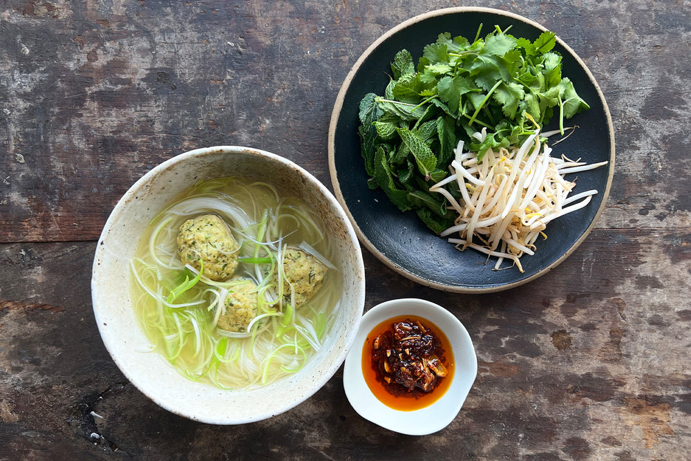 Chicken dumplings in broth, with noodles and chilli oil
