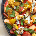 Dukkah crusted feta with heritage tomatoes and melon salad