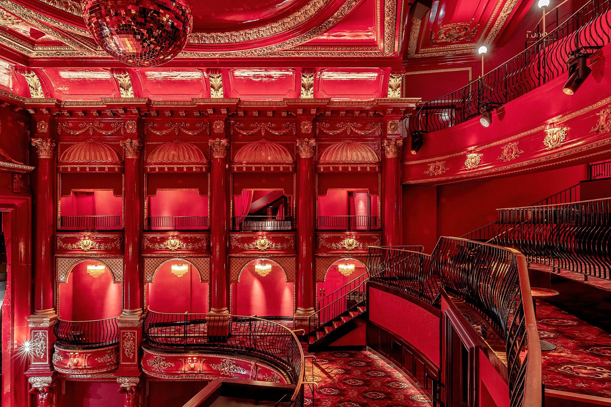 An interior of Koko venue: theatrical loges, deep red walls, and ceiling