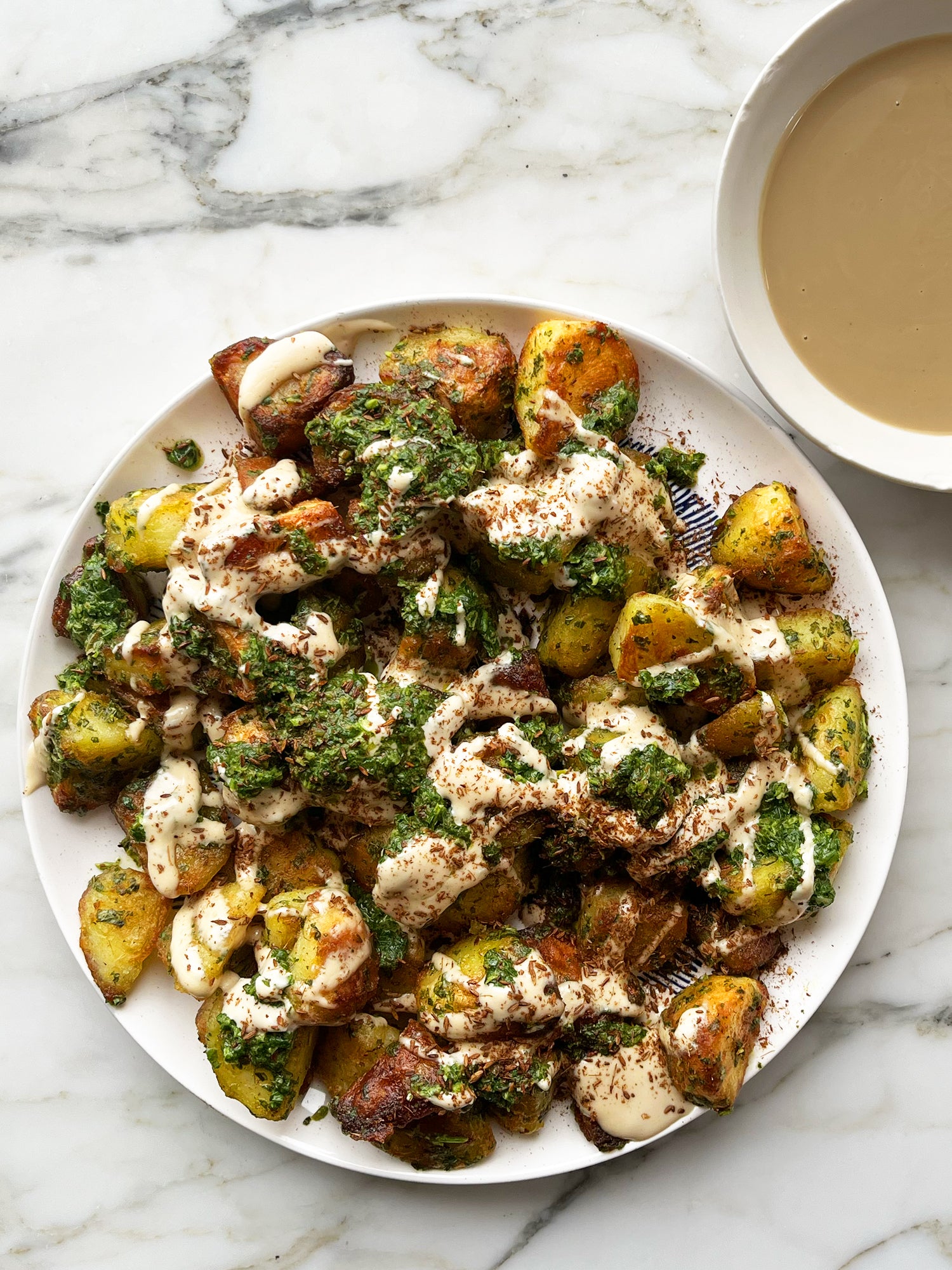 Roast potatoes with green sauce and tahini