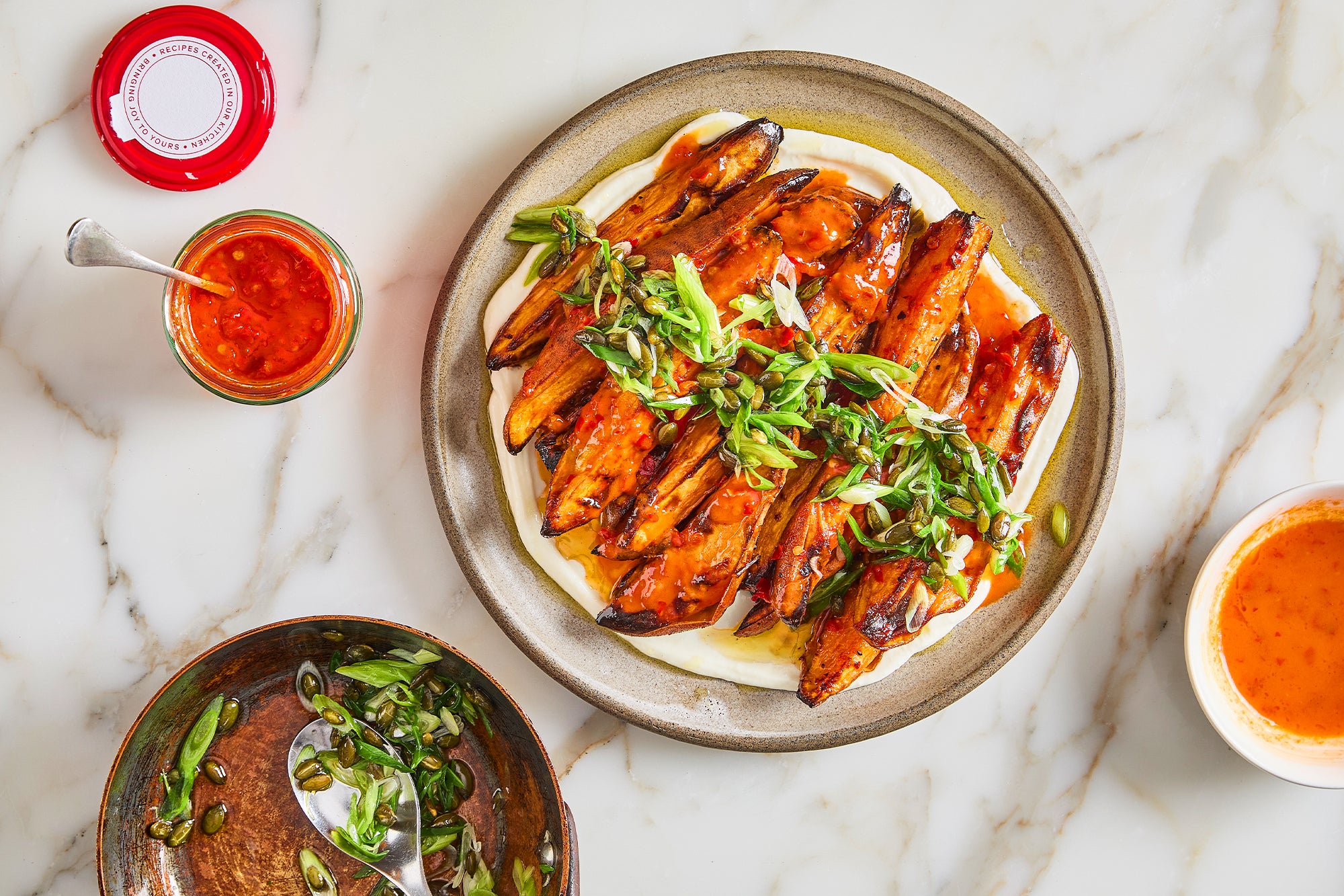 Spicy sweet potatoes with spring onion and pumpkin seed salsa