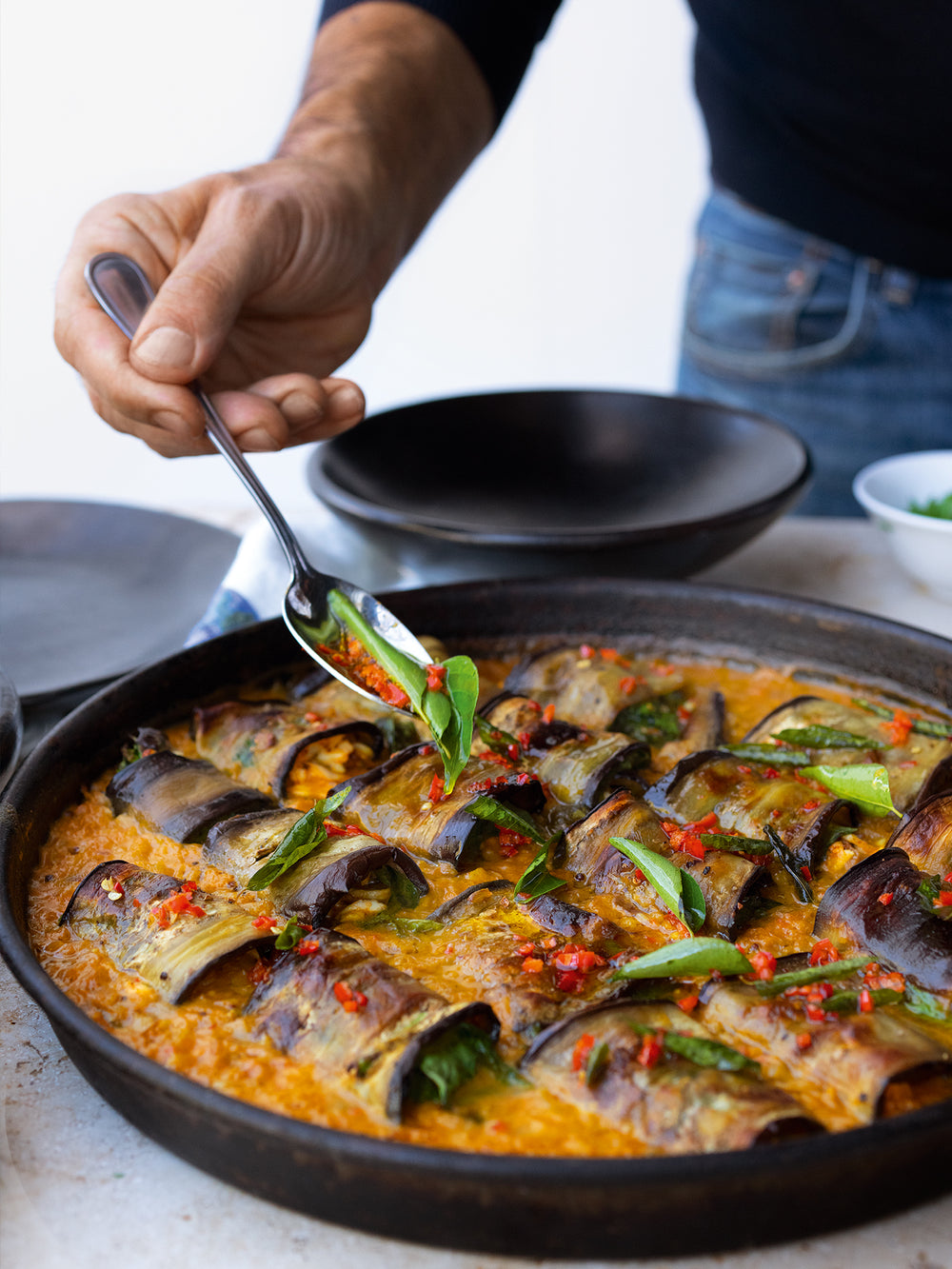 Stuffed aubergine in curry and coconut dal-image