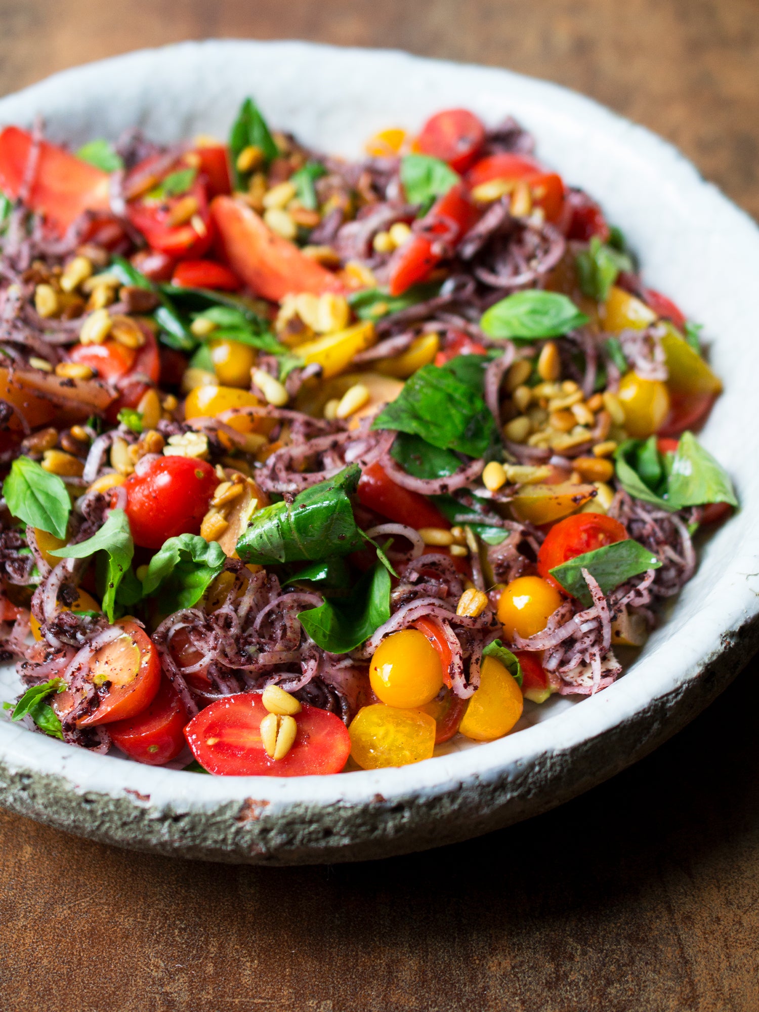 Tomatoes with sumac, onions and pine nuts