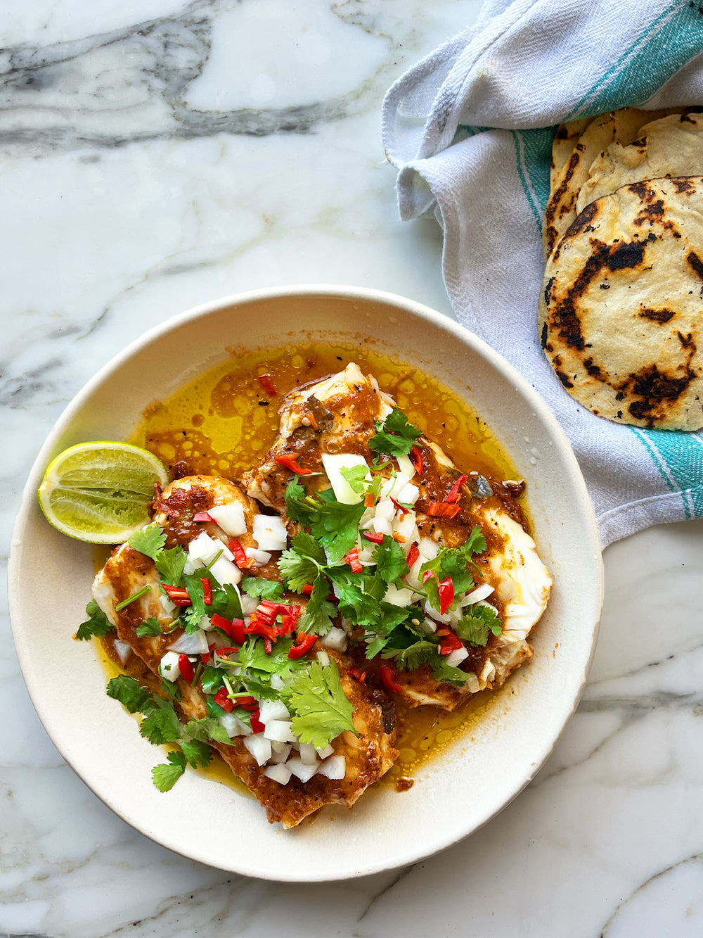 Slow-cooked hake in cascabel oil with corn tortillas