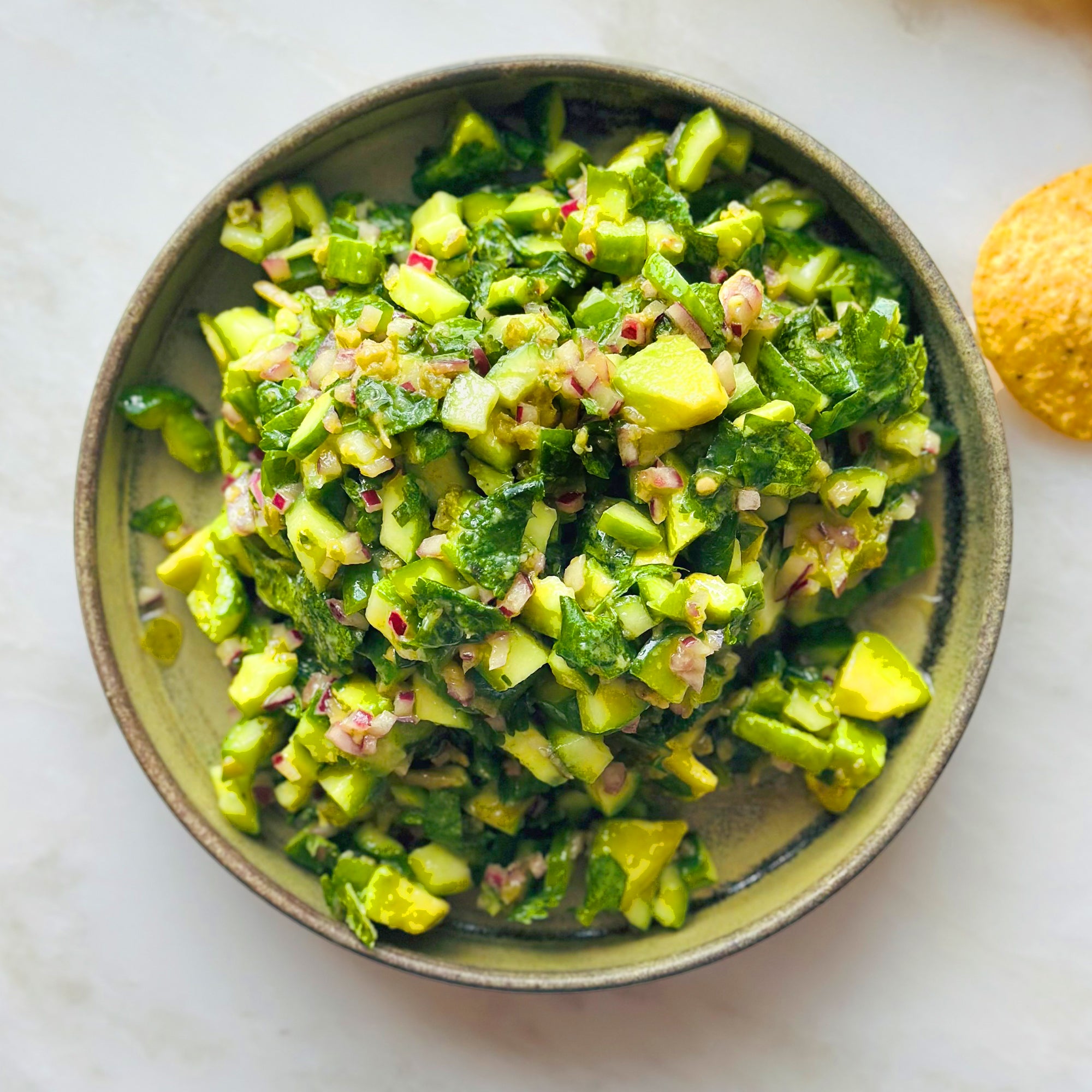 Avocado and cucumber chopped salad with green shatta