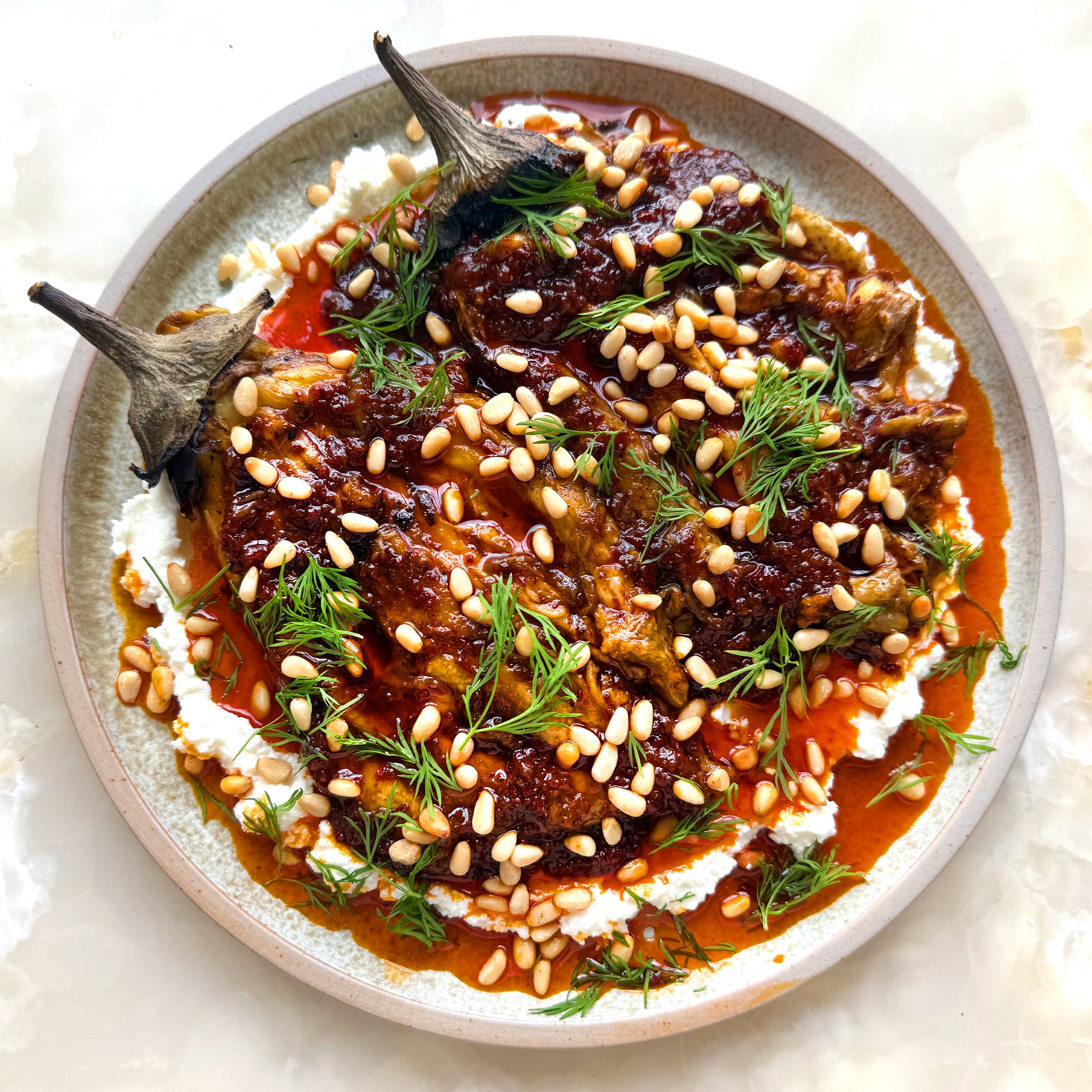 Burnt aubergine with feta and harissa oil