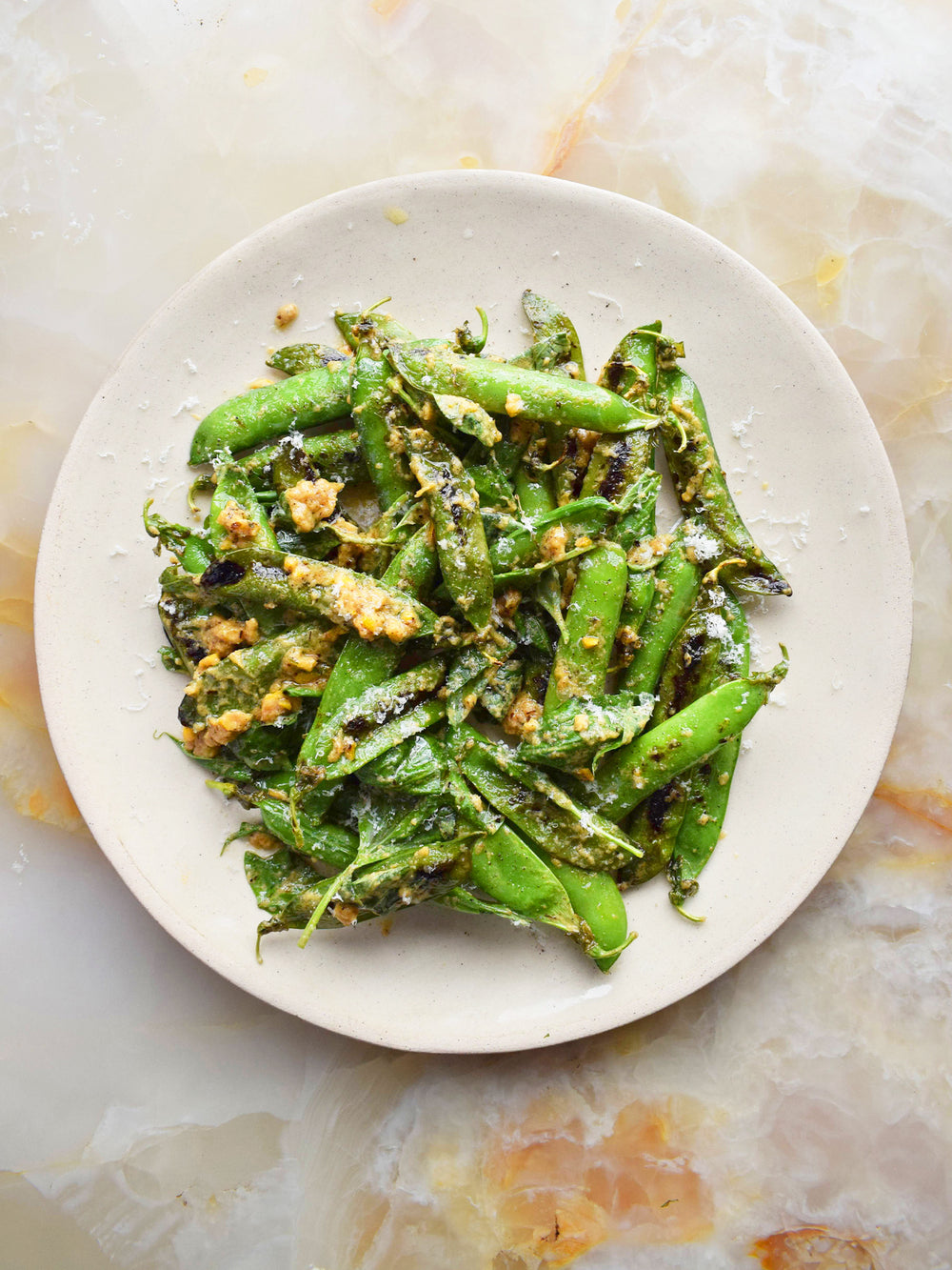 Charred peas with lemon and parmesan dressing