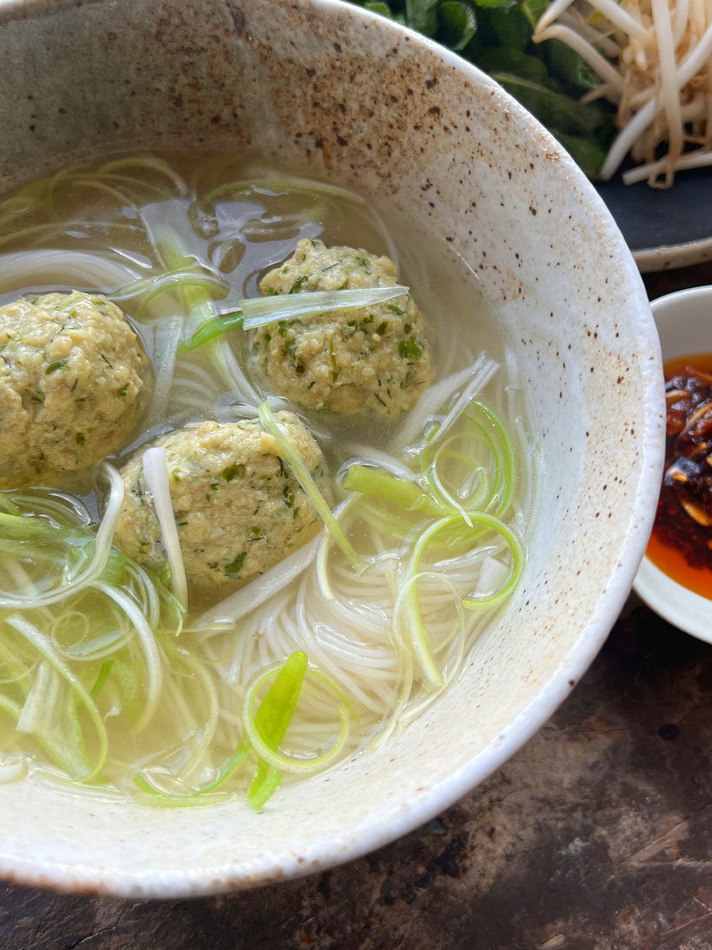  Chicken dumplings in broth, with noodles and chilli oil