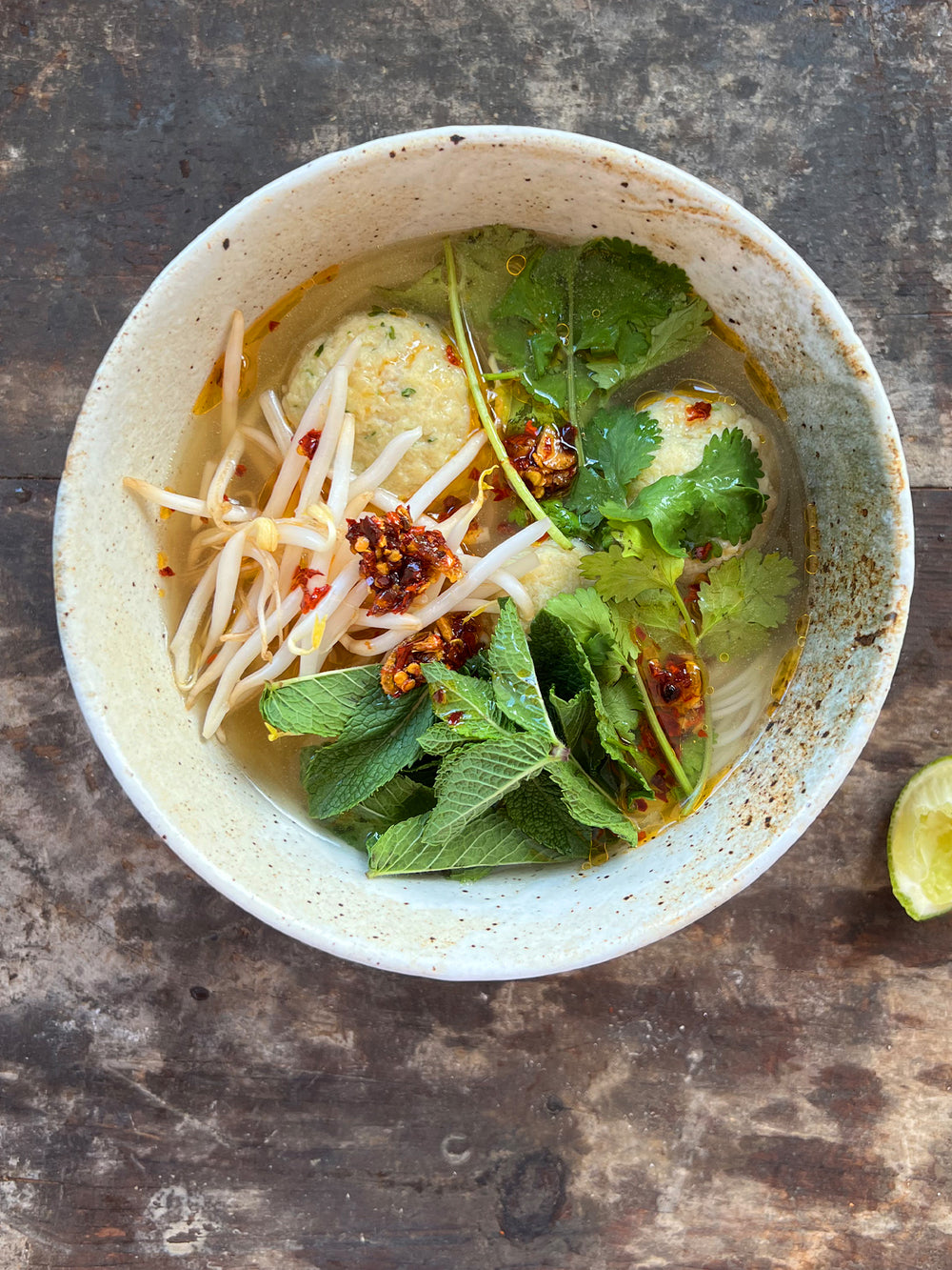  Chicken dumplings in broth, with noodles and chilli oil