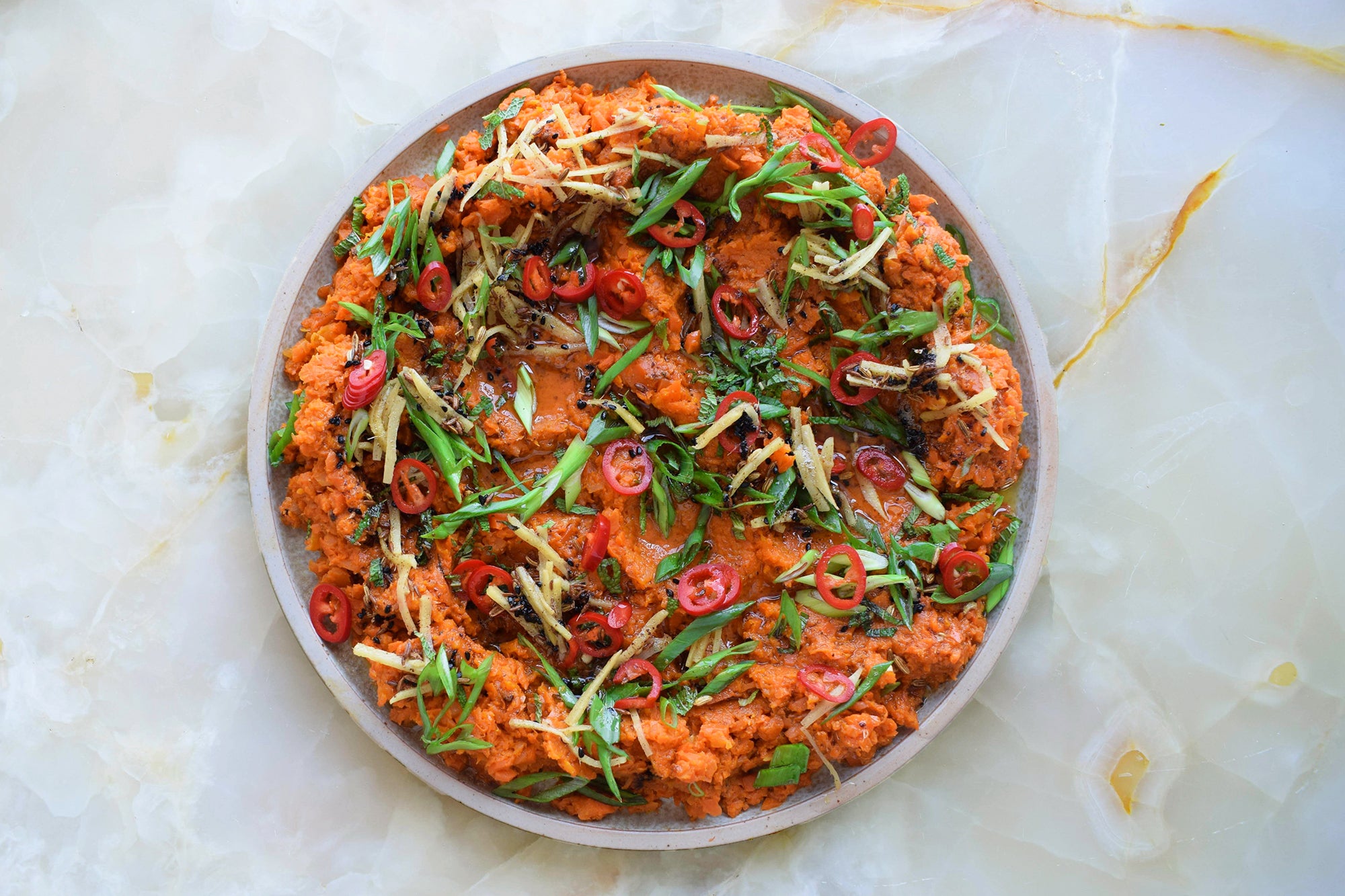 Curried carrot mash with brown butter and quick-pickled chillies