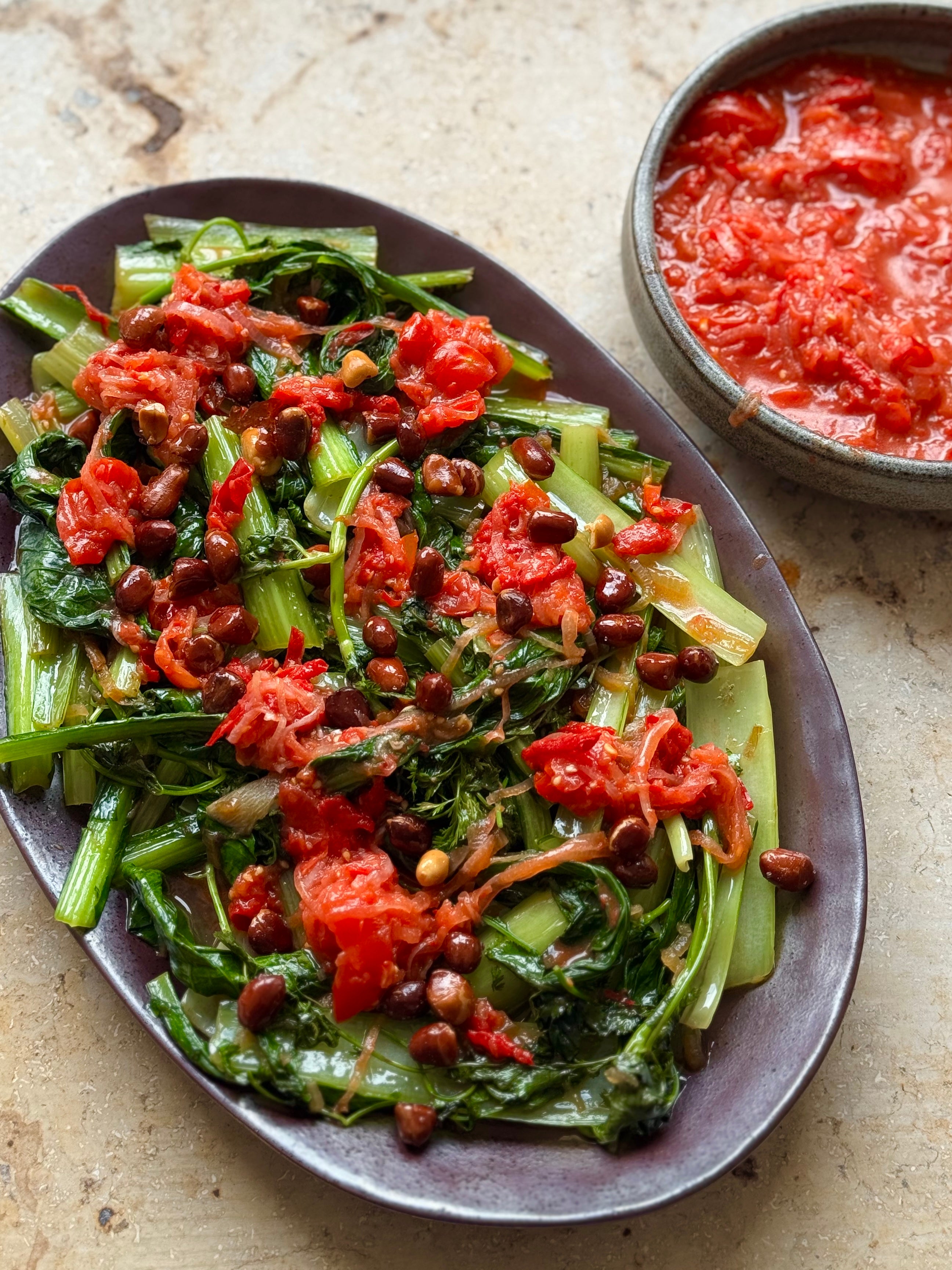 Sauteed greens with smashed tomato sambal and fried peanuts