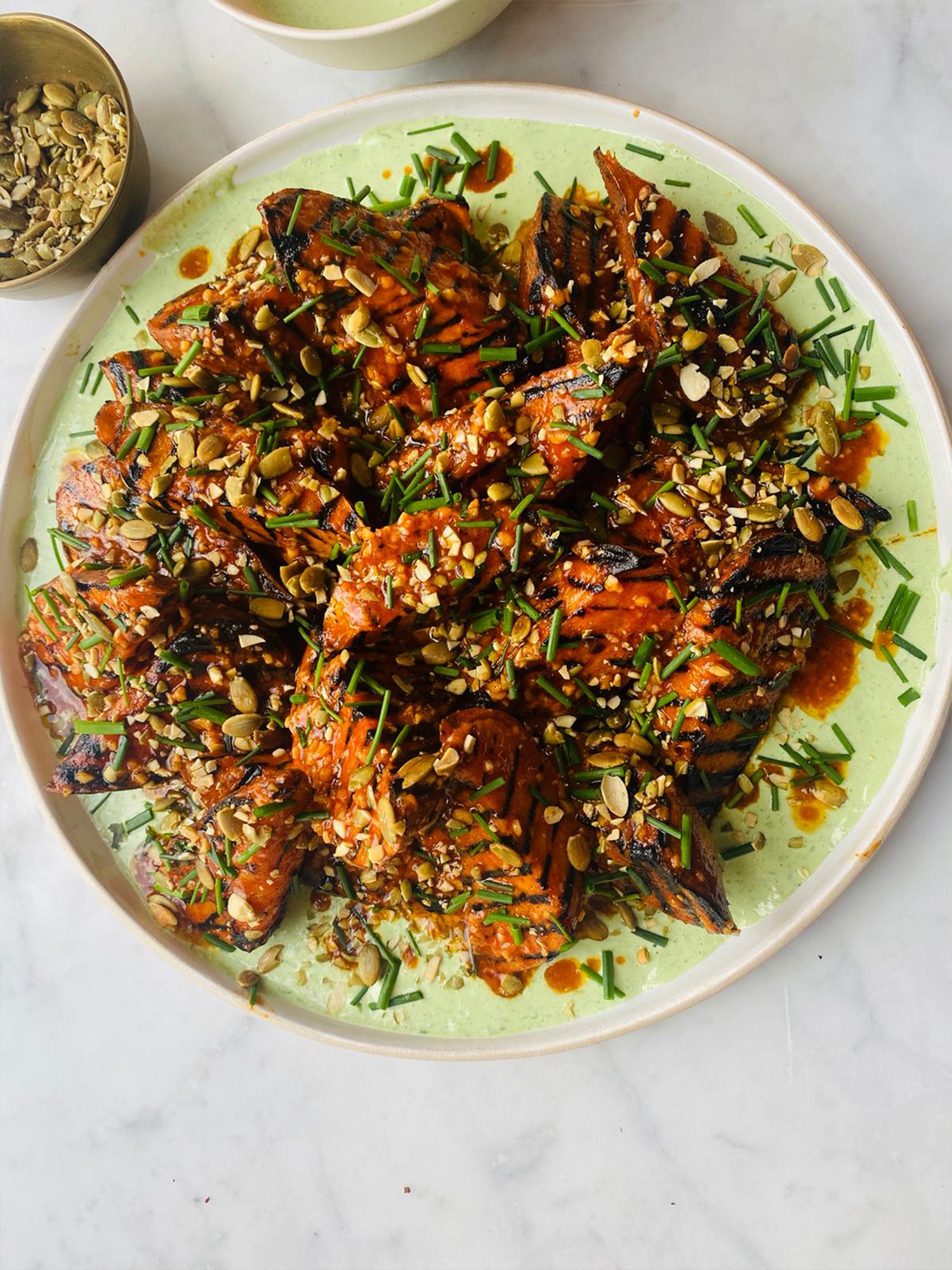Grilled sweet potatoes with hot sauce butter, chive soured cream and pumpkin seeds