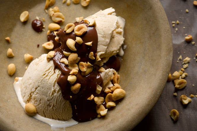 Halva ice cream with chocolate sauce and peanuts