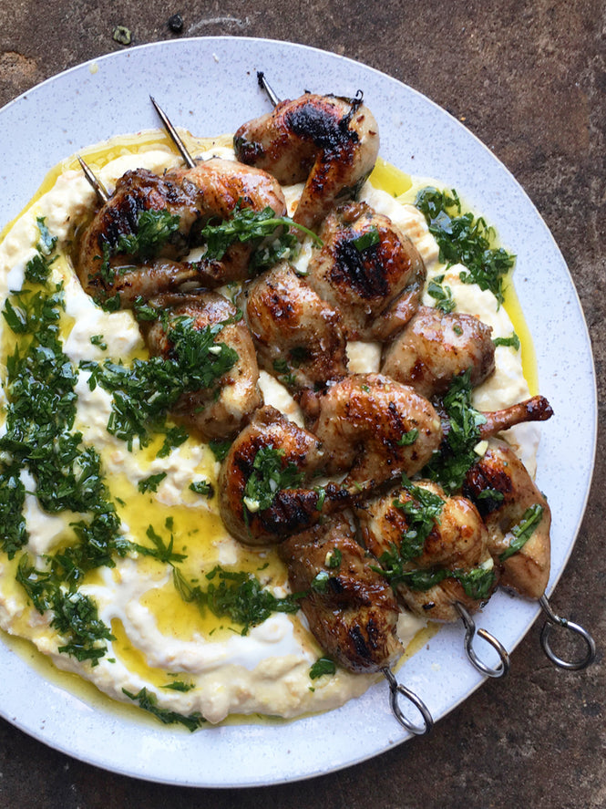 Hummus with grilled quail, pomegranate molasses and parsley salsa