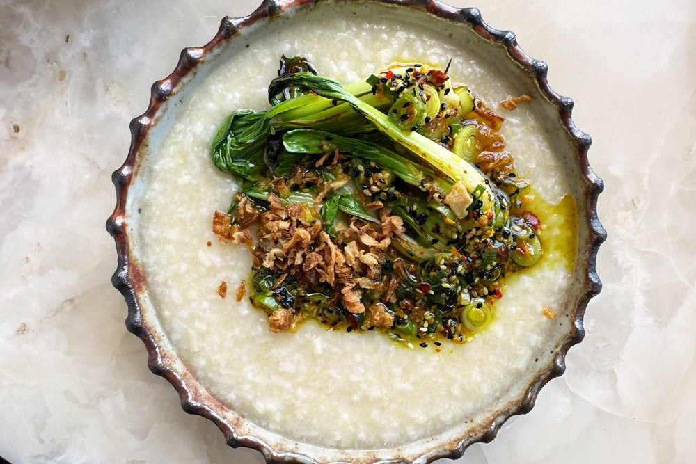 Jook with garlicky choi sum and turmeric oil