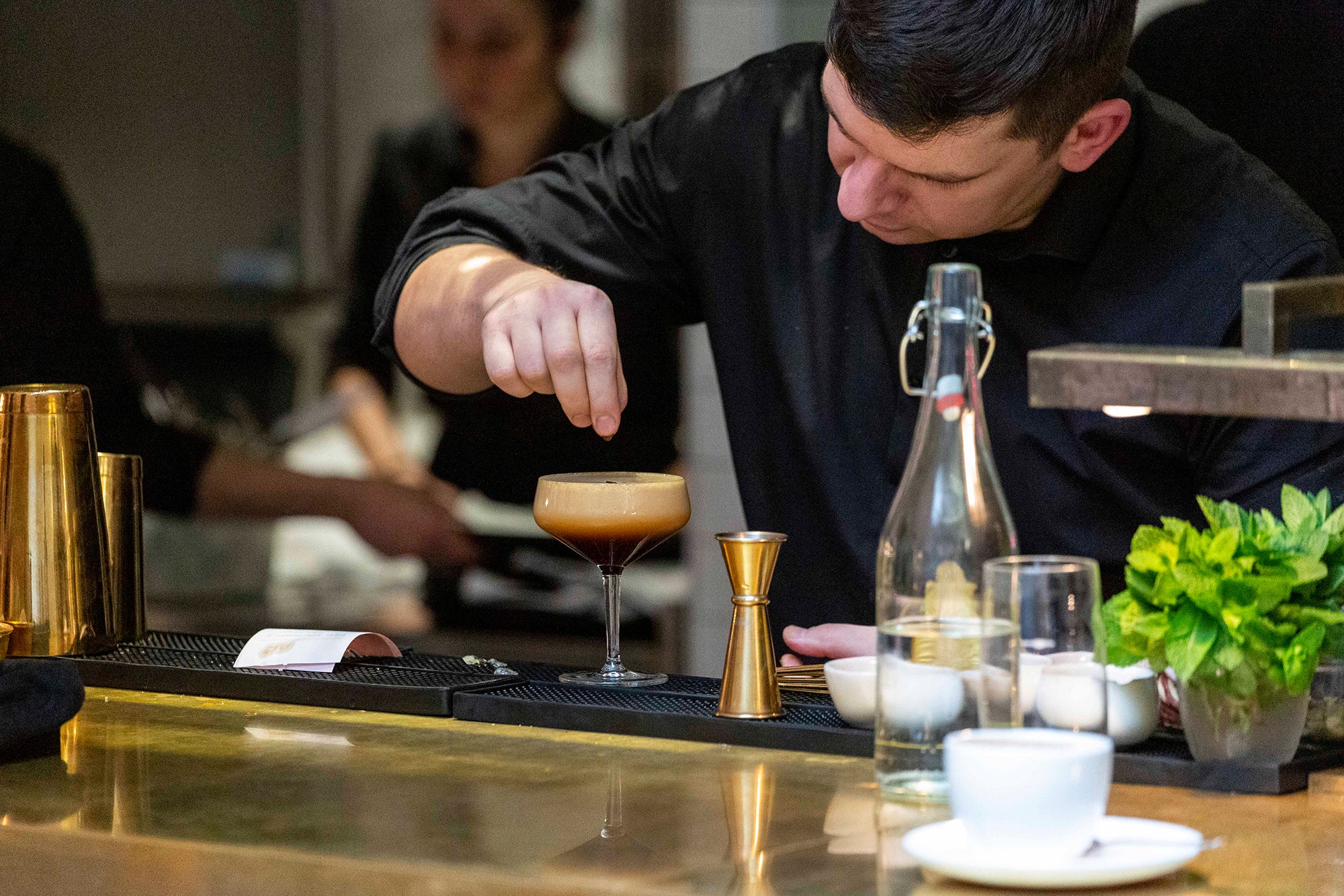 A bartender preparing an espresso martini