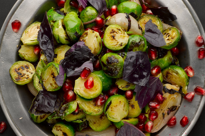 Pan fried brussels sprouts and shallots with pomegranate and purple basil