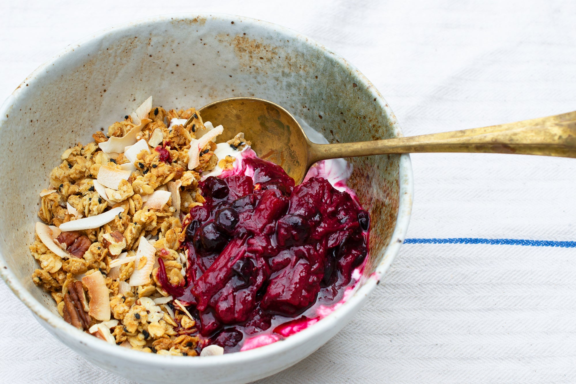 Pecan and coconut granola with roasted rhubarb and blackcurrants