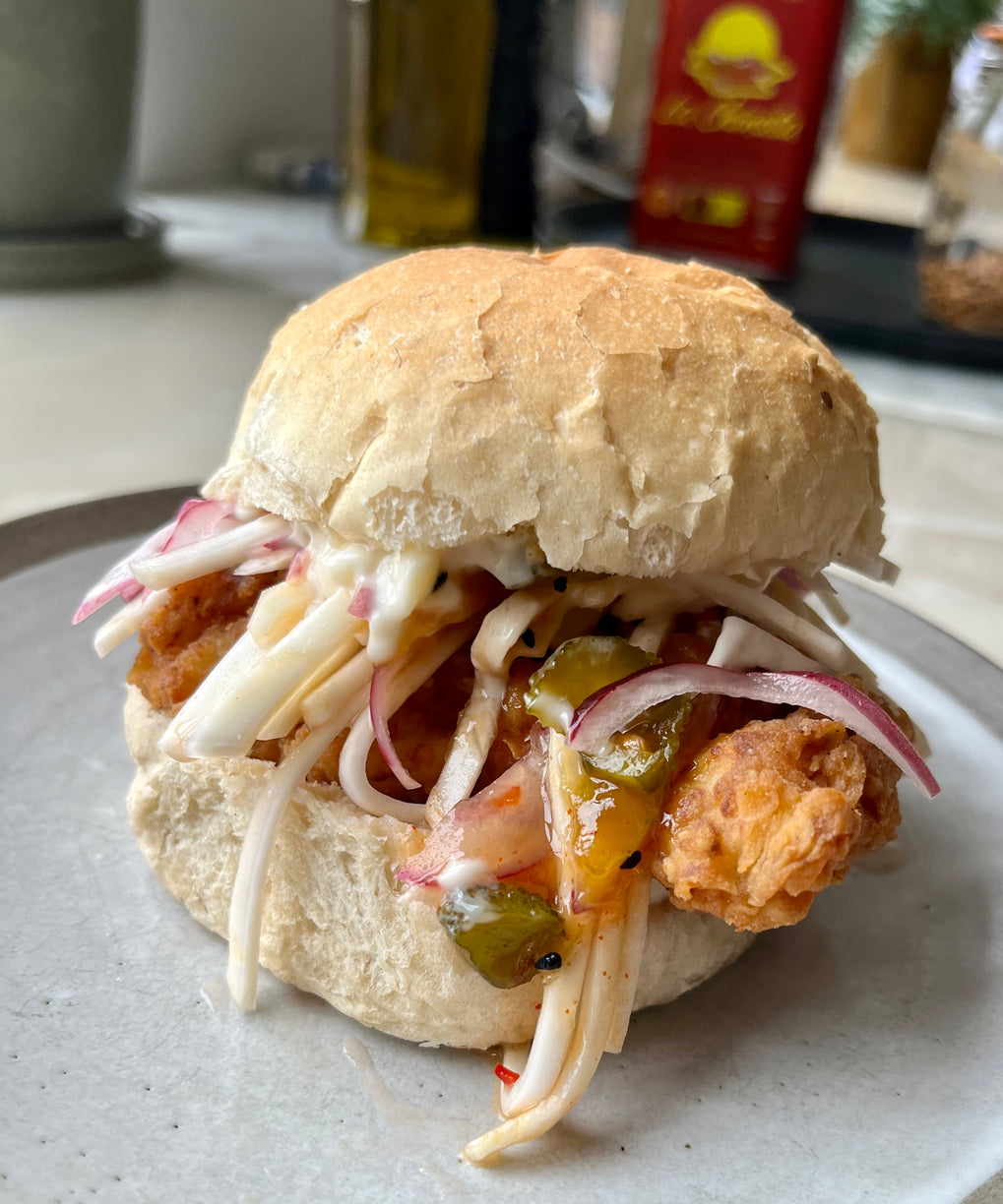 Curried fried chicken burger with sweet mango relish and celeriac slaw