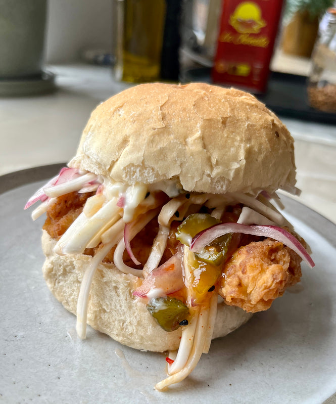 Curried fried chicken burger with sweet mango relish and celeriac slaw