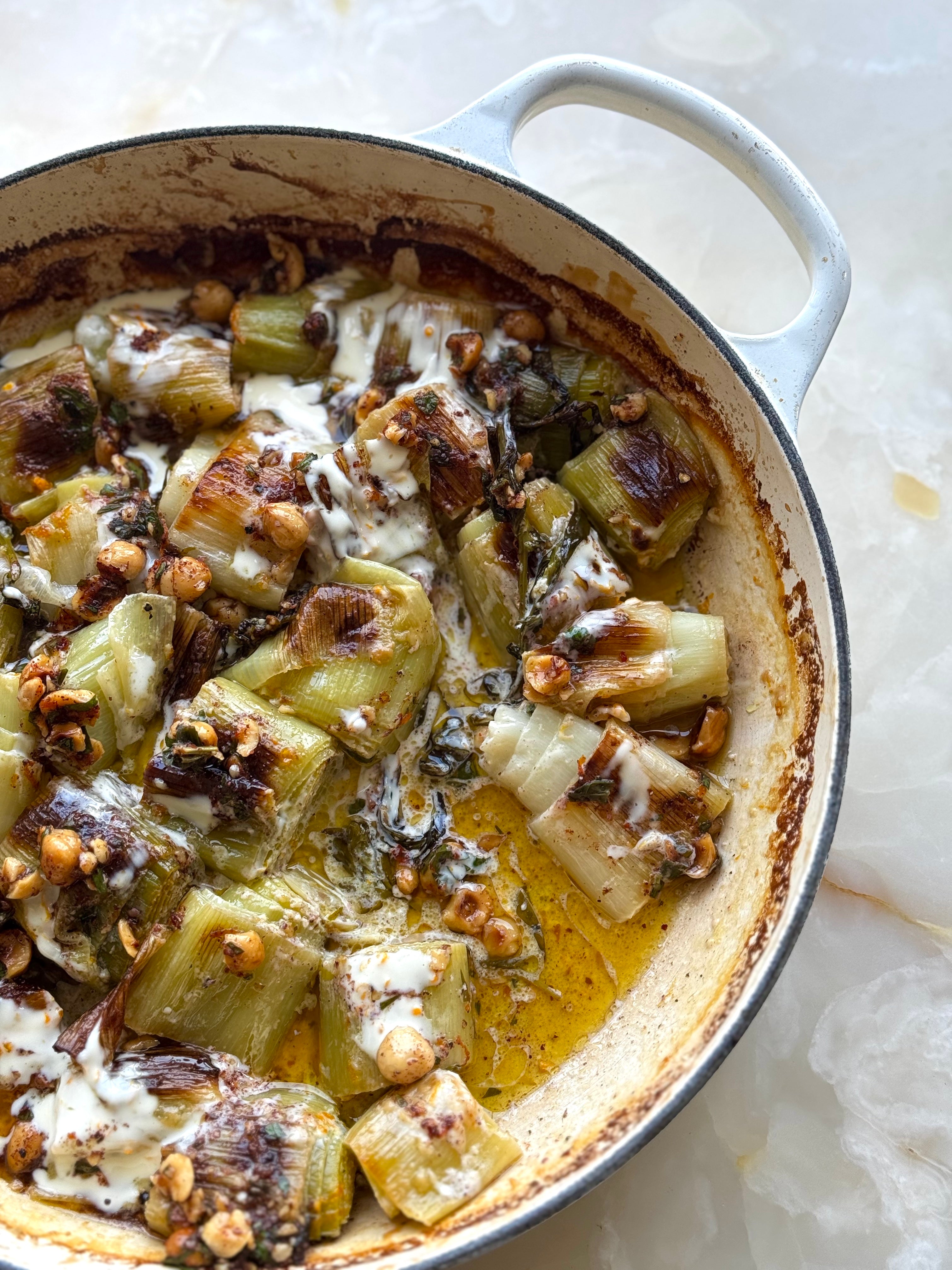 Roasted leeks with crème fraîche, hazelnuts and sumac