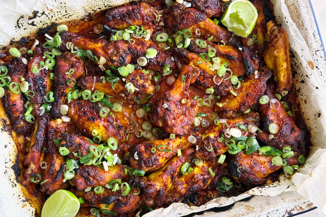 Sweet and smokey chicken wings with spring onions and lime
