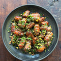 Sticky pomegranate and pistachio pigs in blankets