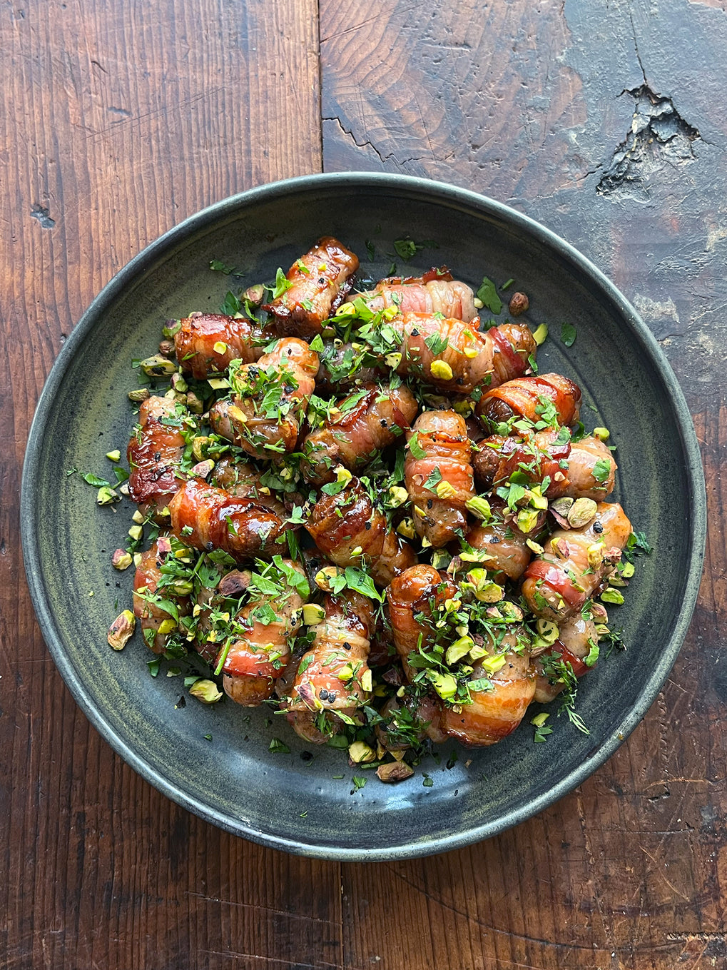 Sticky pomegranate and pistachio pigs in blankets