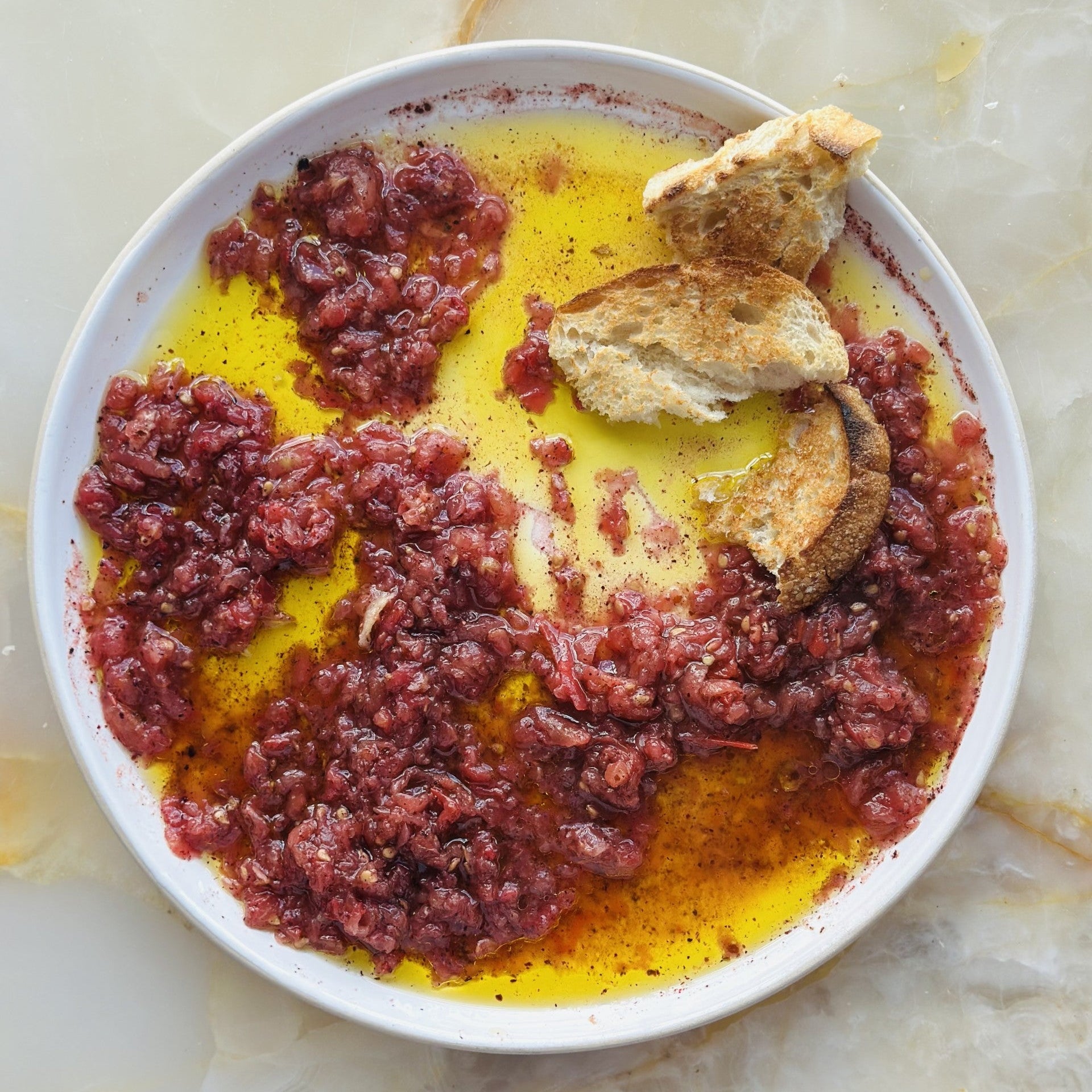 Grated sumac, tomato and olive oil dip