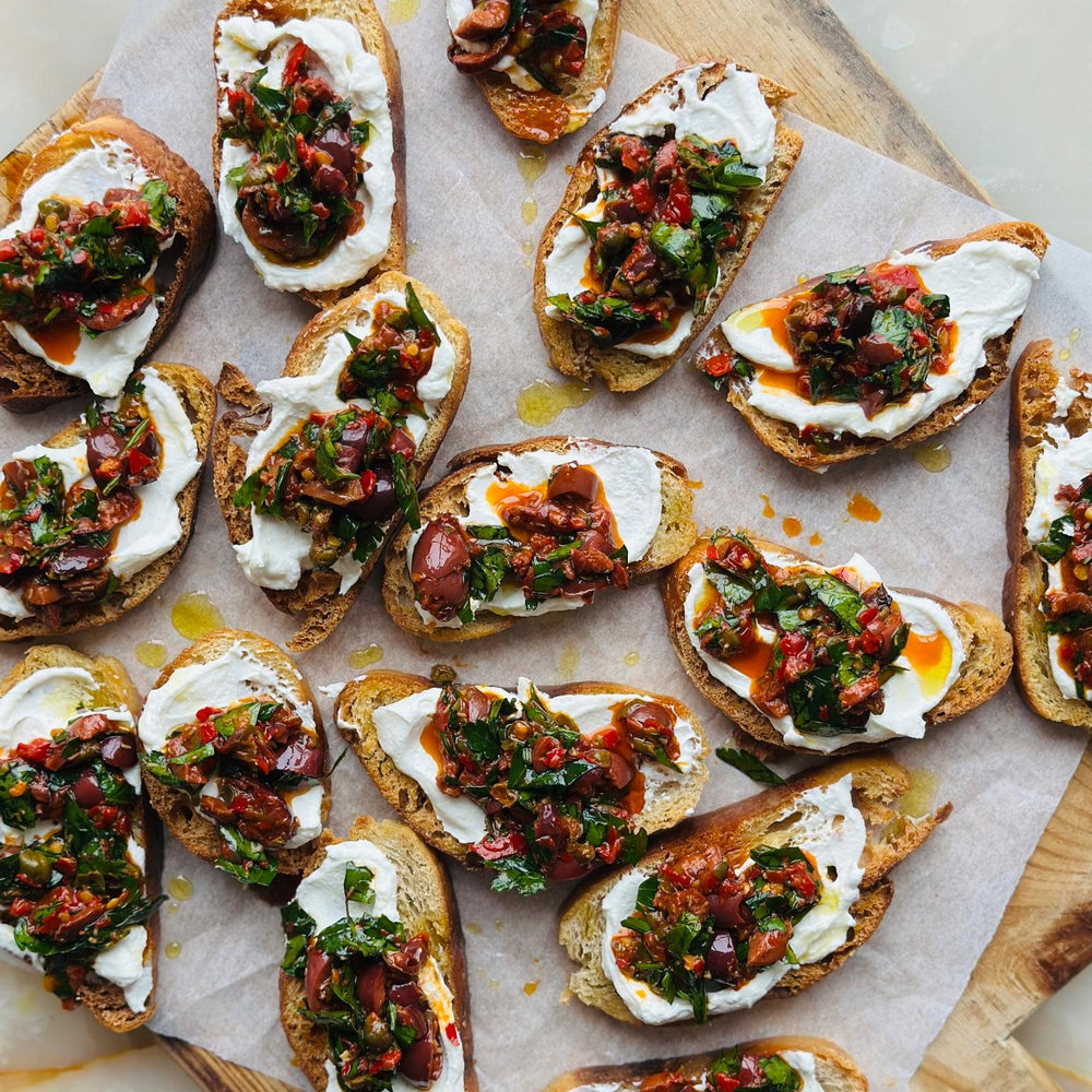 Puttanesca crostini with whipped ricotta