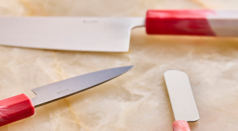 three knives on a marble surface
